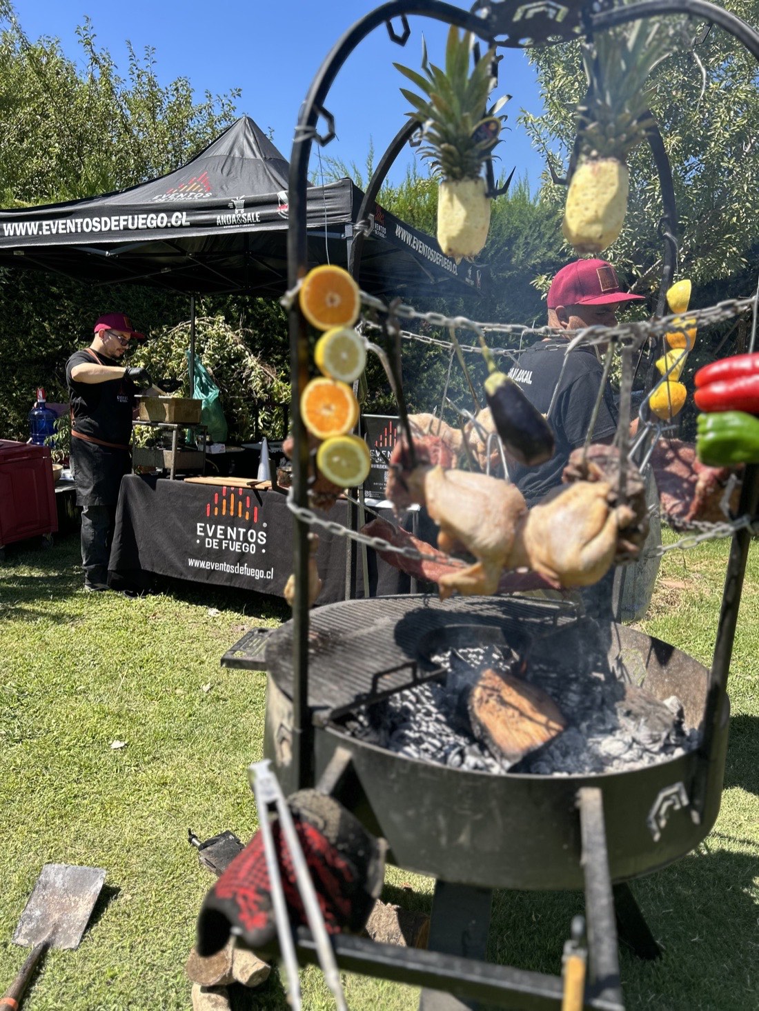 Parrilleros de Eventos de Fuego preparando pollo y verduras al fuego