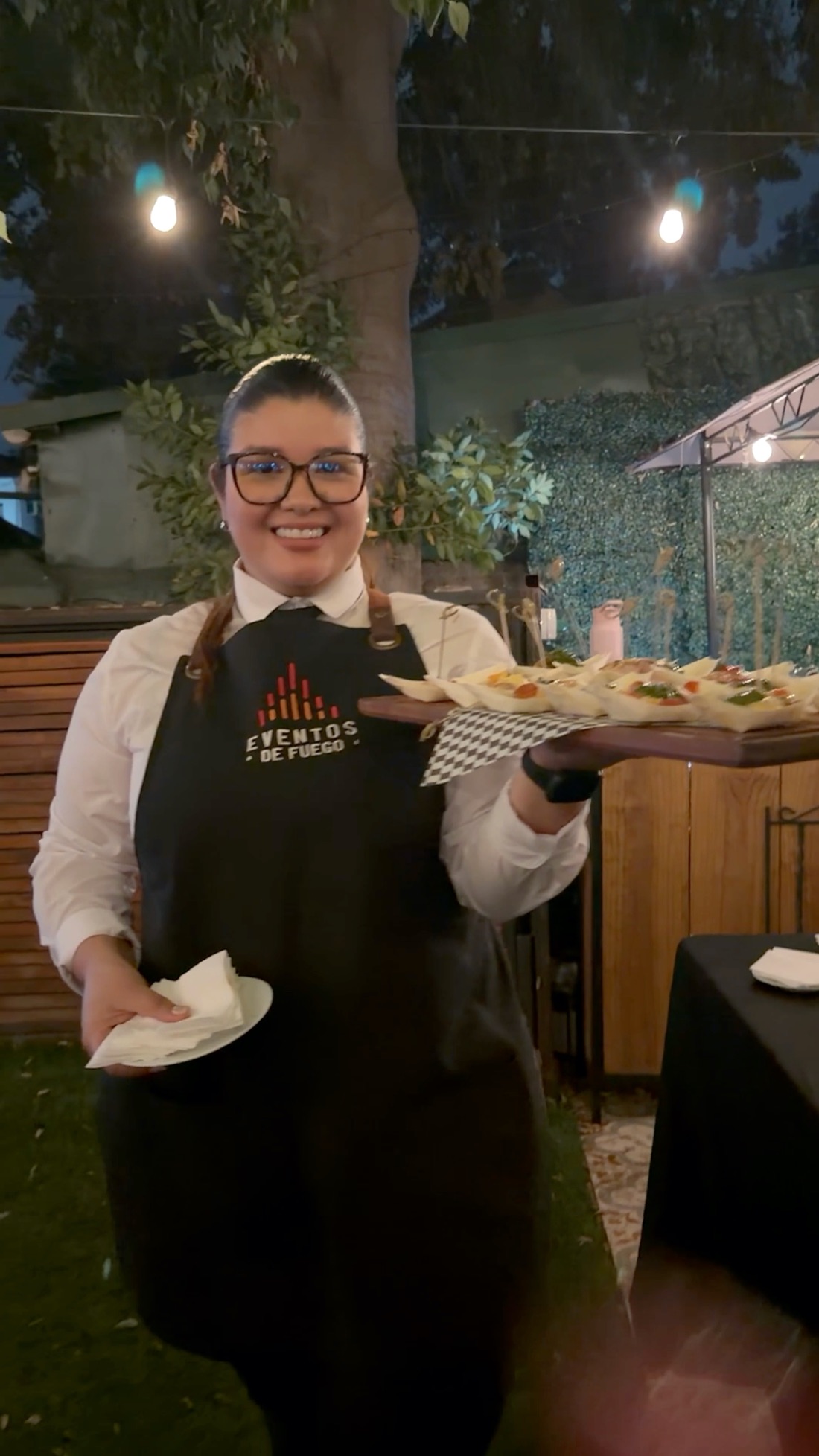 Garzona de Eventos de Fuego sirviendo bocados en un evento